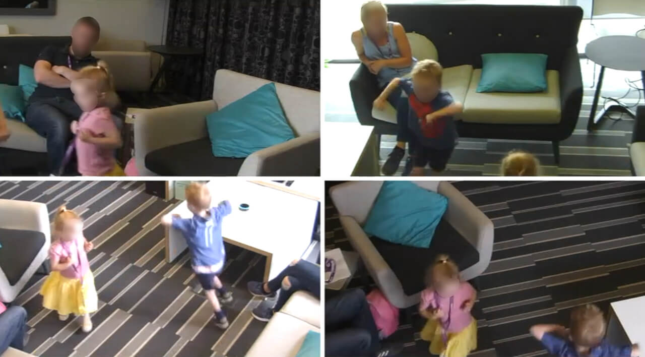 A screenshot from a user research session showing two children dancing around in front of a smart speaker